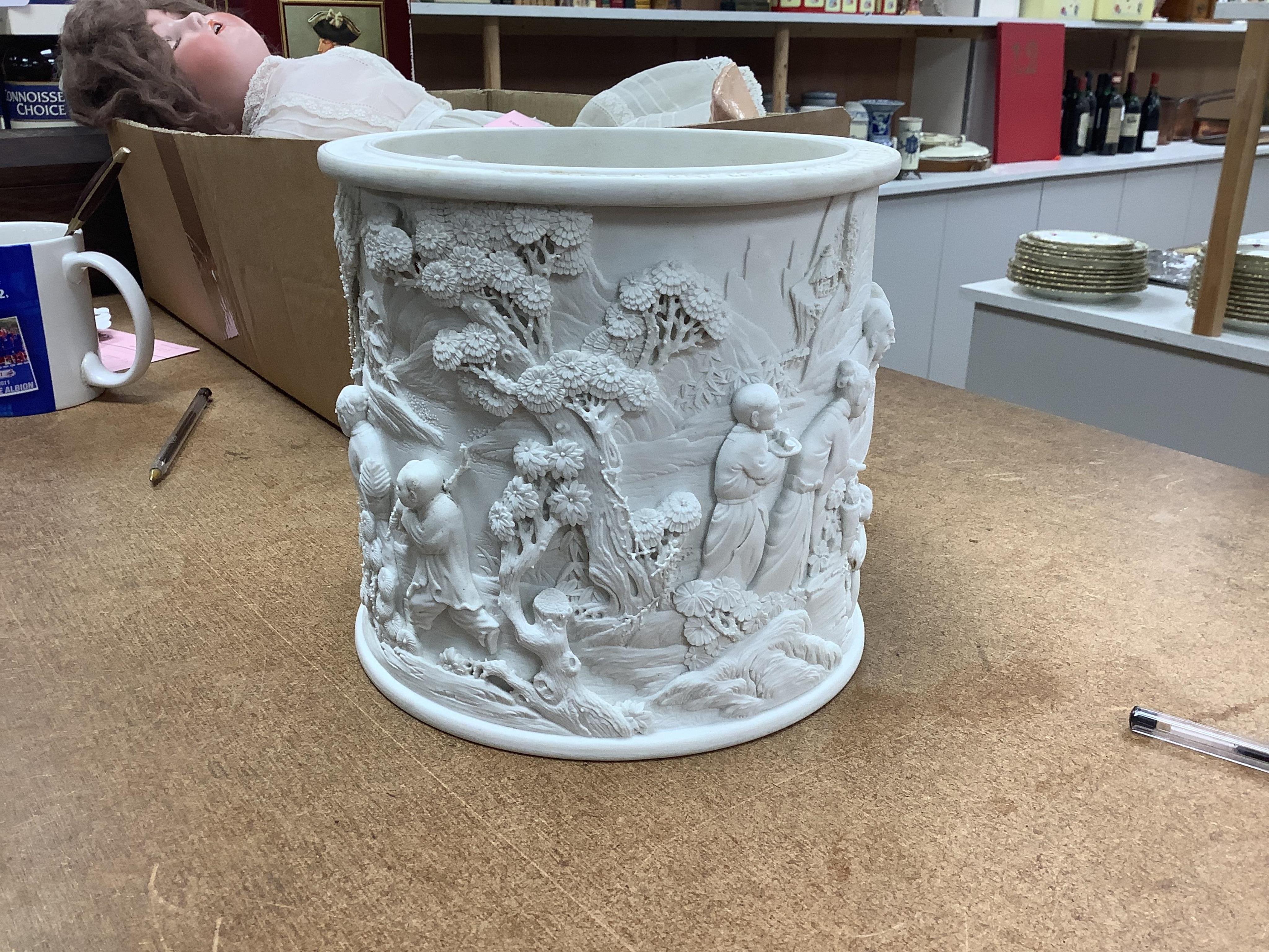 A Chinese biscuit porcelain ‘scholars’ brushpot, Daoguang mark but later, 17cm. Condition - fair to good